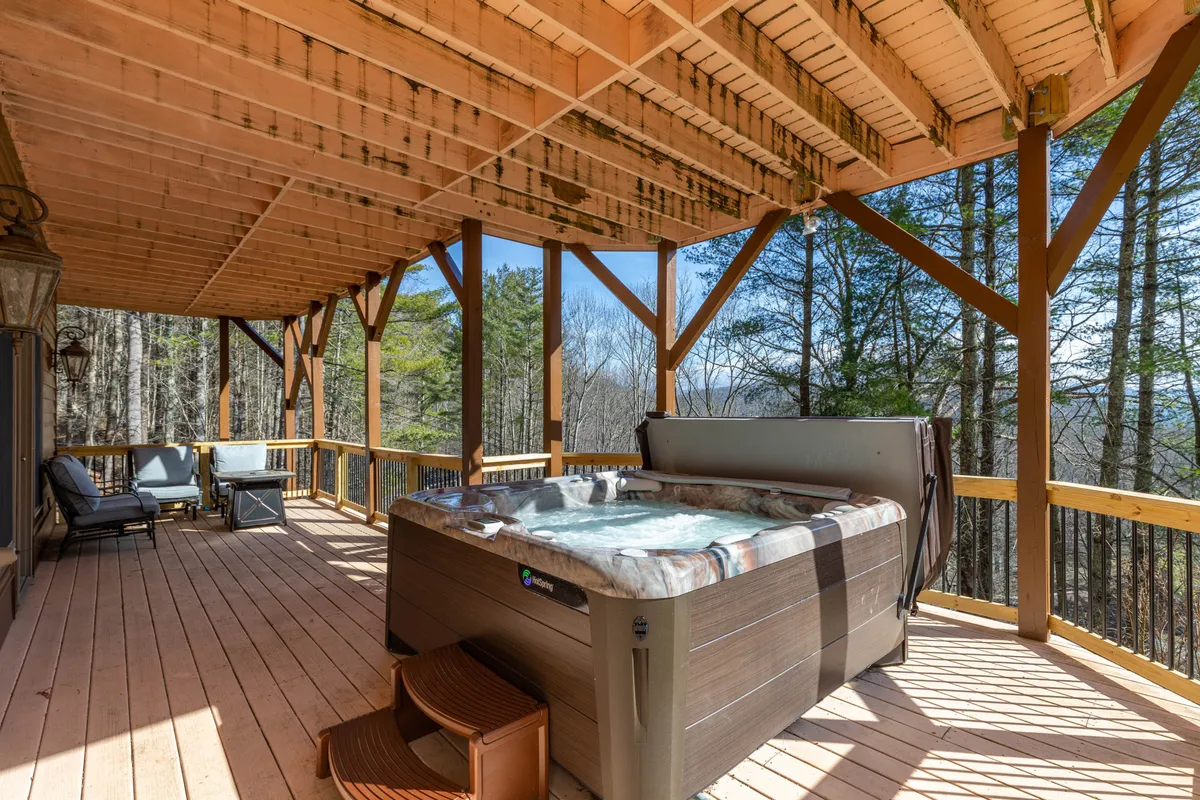 Nestled on the wooden lower deck and surrounded by trees, the bubbling hot tub offers tranquil views of nature. The deck provides a peaceful outdoor escape, where guests can soak sore muscles and enjoy the changing scenery from the comfort of the warm water.